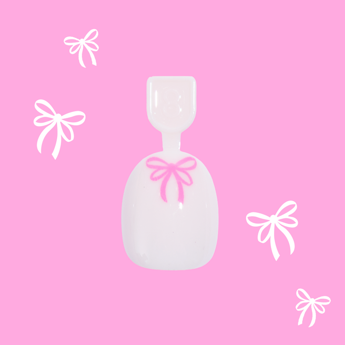 Pink Everything Please - Pressies | Extra Short Short | Round showing baby pink press-on nail with bright pink bow design on pink background