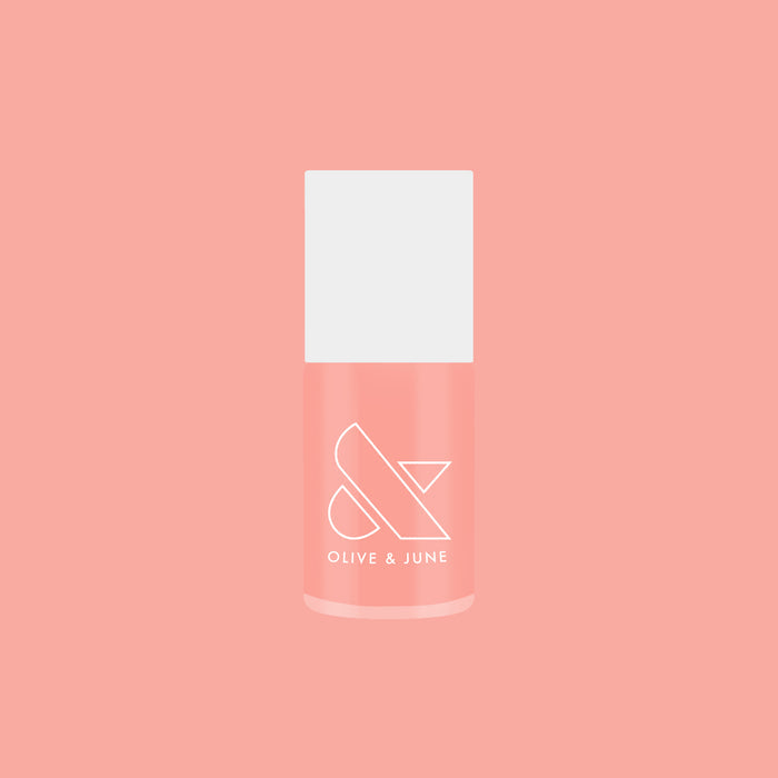 Pink Pineapple Gloss nail polish bottle on peach pink background for subtle glossy at home manicure