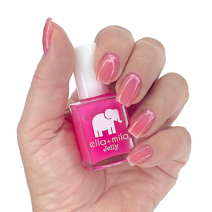 Pink Sand Beach pink jelly nail polish on a medium skin tone, hand holding the bottle