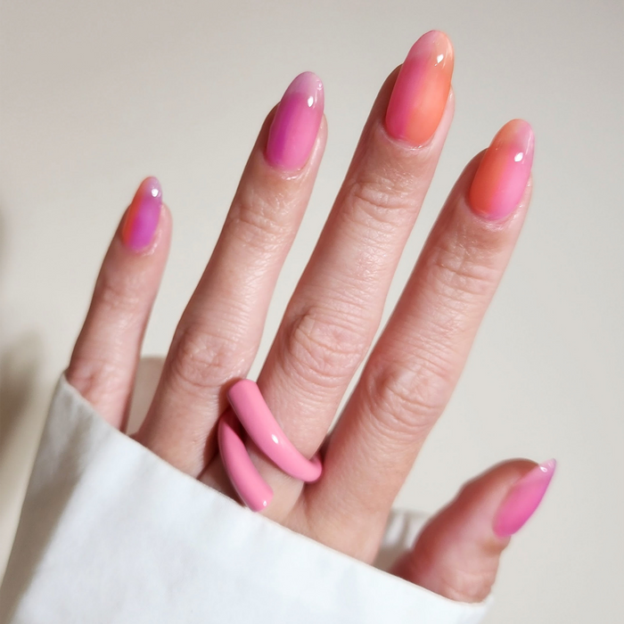 Pink Sand Beach pink with peach and lilac jelly mix-and-match manicure in sunlight