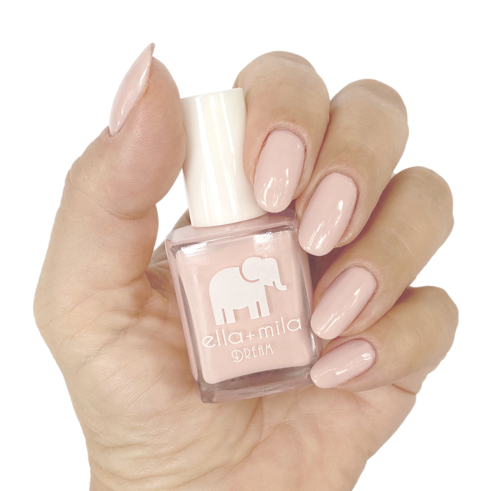 Pirouette warm nude pink nail polish manicure on a light skin tone with the bottle