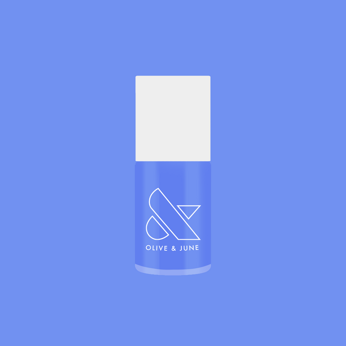 Bottle of Rally Ready nail polish in dusty ultramarine blue by Olive and June for long-lasting at-home mani and pedi