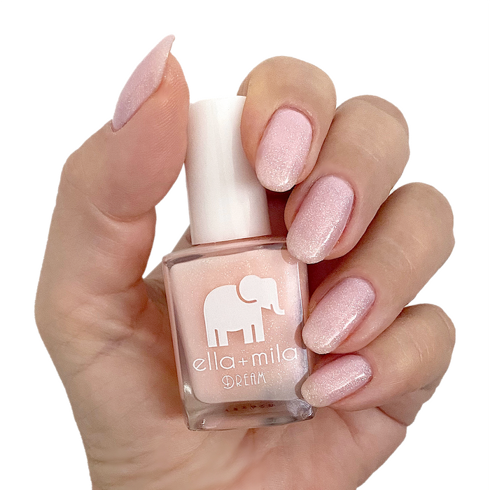 Relevé sheer pink shimmer nail polish manicure on a light skin tone with the bottle
