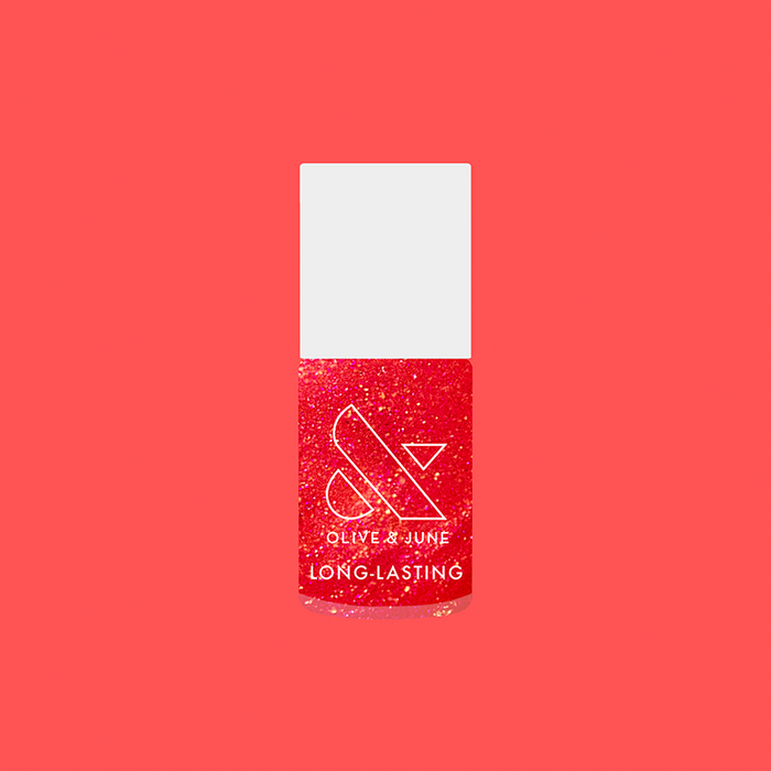 Rodeo Queen nail polish bottle with bright pinky-red color and silver shimmer for long-lasting at-home manicure