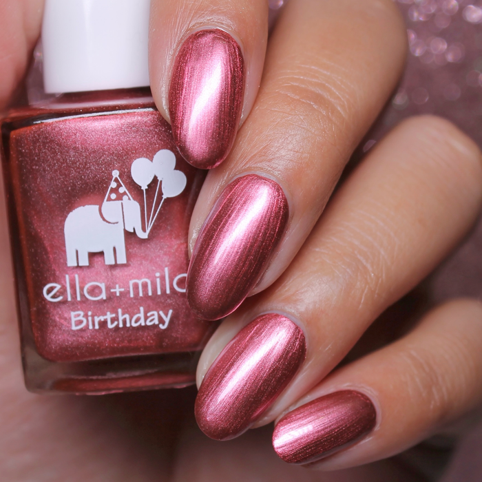 Rosy Quartz rose gold pink shimmer nail polish close-up with the bottle