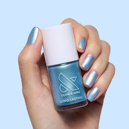 Same Day Next Year shimmery sheer blue polish on nails with a glossy finish for a long-lasting mani by Olive and June