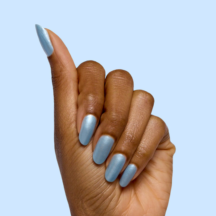 Same Day Next Year shimmery sheer blue polish on medium-length nails with a smooth finish by Olive and June