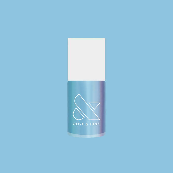 Same Day Next Year shimmery sheer blue nail polish bottle against a soft blue background by Olive and June