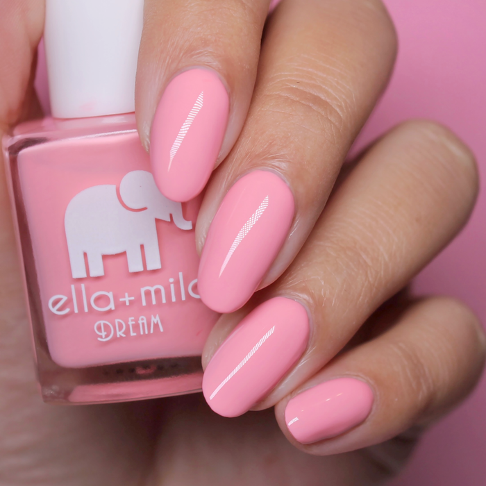 Set the Barre High rosy peach-pink nail polish close-up with the bottle on a pink background