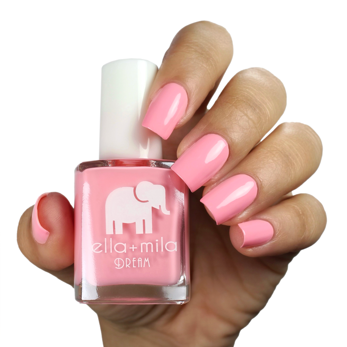 Set the Barre High rosy peach-pink nail polish on a medium skin tone, hand holding the bottle