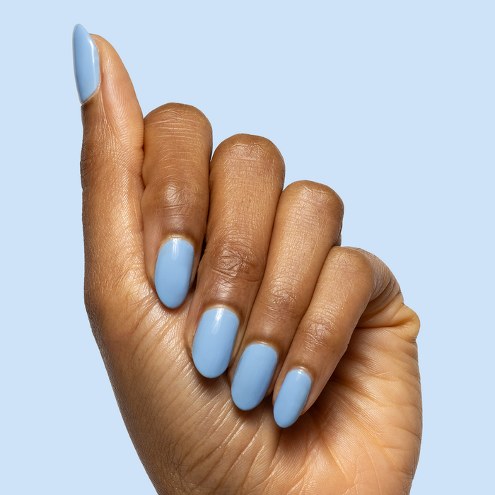 Hand with almond-shaped nails painted in glossy Shades of Seersucker for a fresh, preppy gel manicure look
