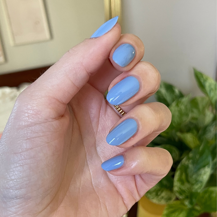 Hand with smooth gel polish nails painted in Shades of Seersucker showing a glossy, soft periwinkle manicure look