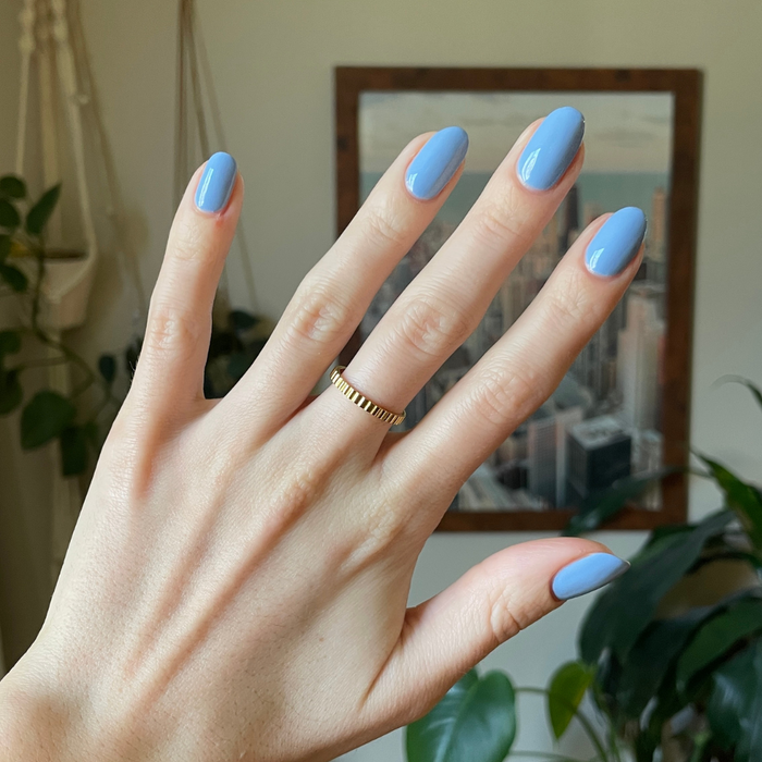 Hand with glossy gel polish nails painted in Shades of Seersucker showing a smooth, summery manicure look