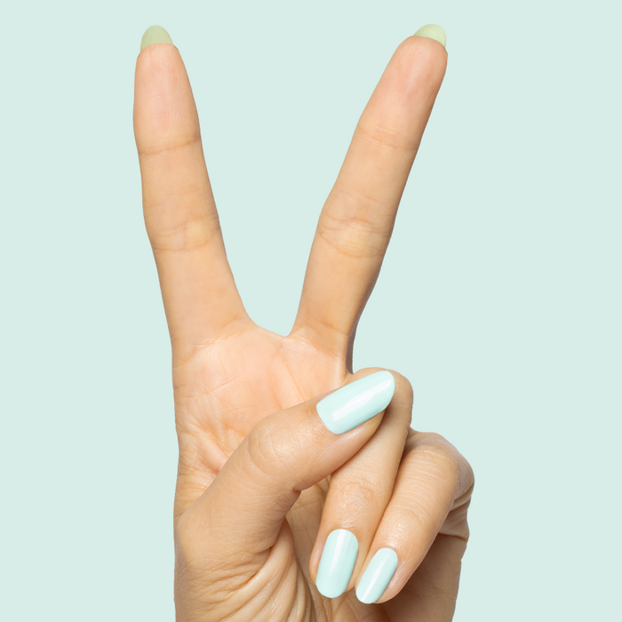 Hand showing peace sign with nails painted in light turquoise using Slam Dunk long-lasting gel polish