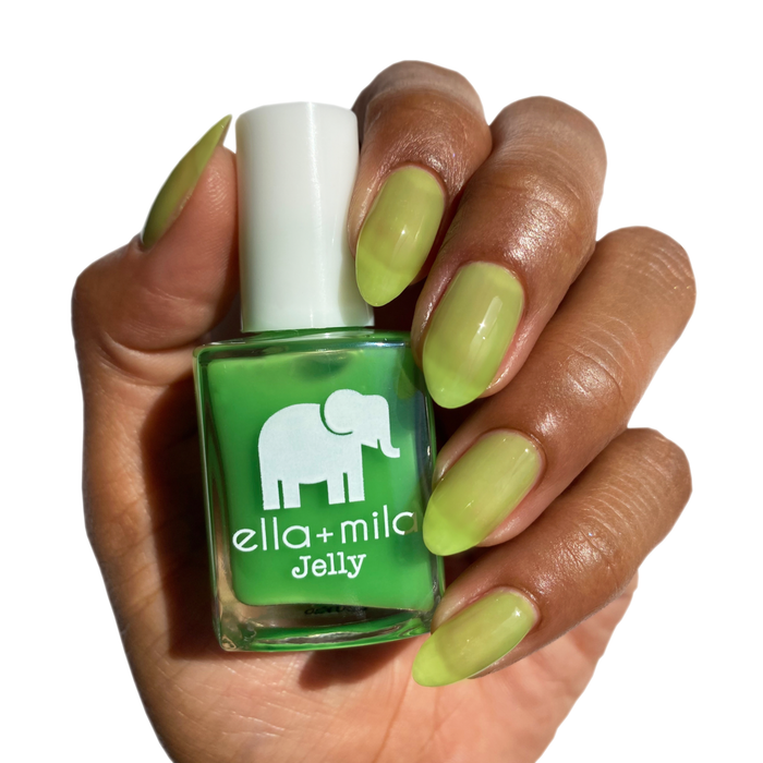 So Lime bright green jelly nail polish on a deep skin tone, hand holding the bottle