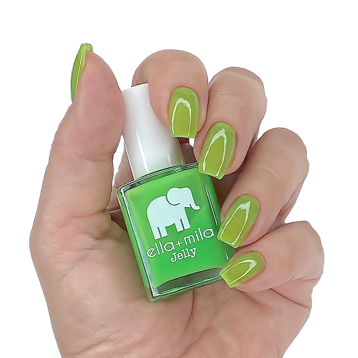 So Lime green jelly nail polish on a medium skin tone, hand holding the bottle
