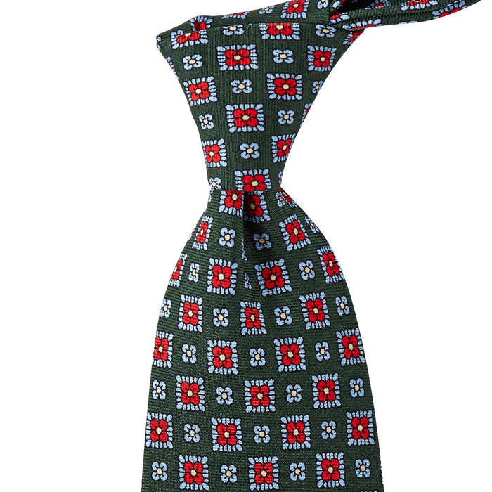 A green Sovereign Grade Forest 36oz Printed Silk Maccesfield tie with red and blue designs, handmade in the United Kingdom using 100% English silk by KirbyAllison.com.