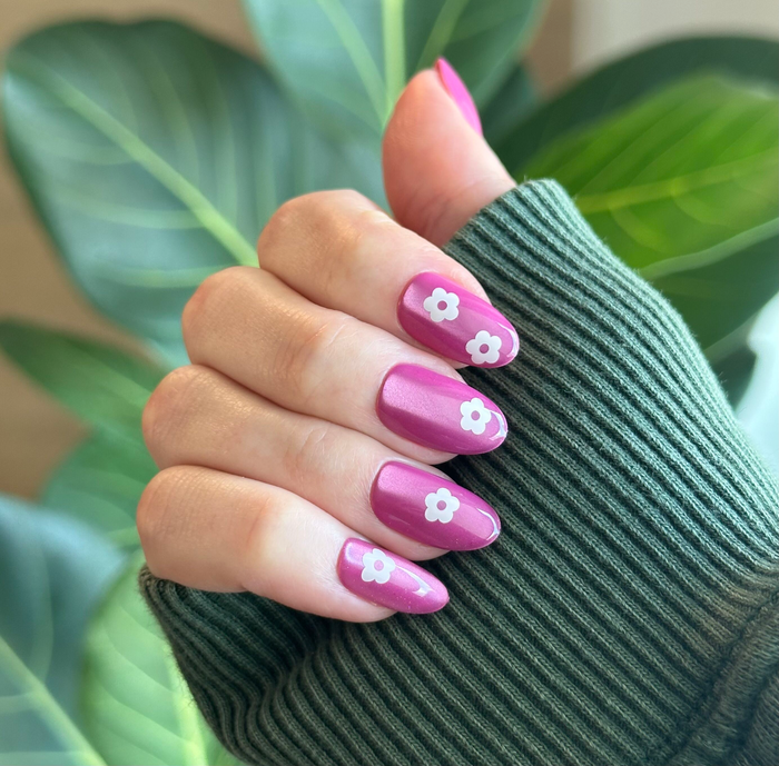 Sparkle Floral - Press-On | Medium | Oval nails with bright pink polish and simple white flower designs for a fresh mani look