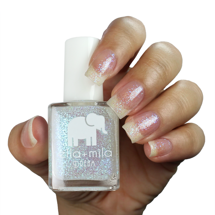 Spin Me Round iridescent shimmer nail polish manicure on a light skin tone with the bottle