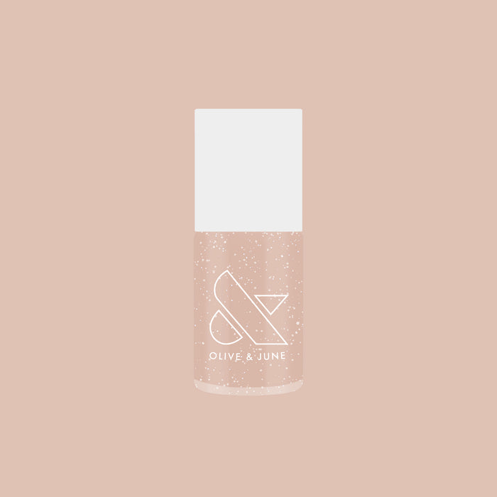 Olive and June Starfruit Shimmer Gloss nail polish bottle with warm champagne shimmer on soft beige background