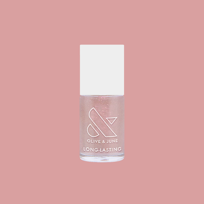 Clear bottle of Starshower rose gold glitter polish by Olive and June for long-lasting at home manis and manicures