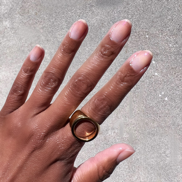 Hand with natural nails adorned with delicate rose gold shimmer using Starshower polish for an elegant at home mani