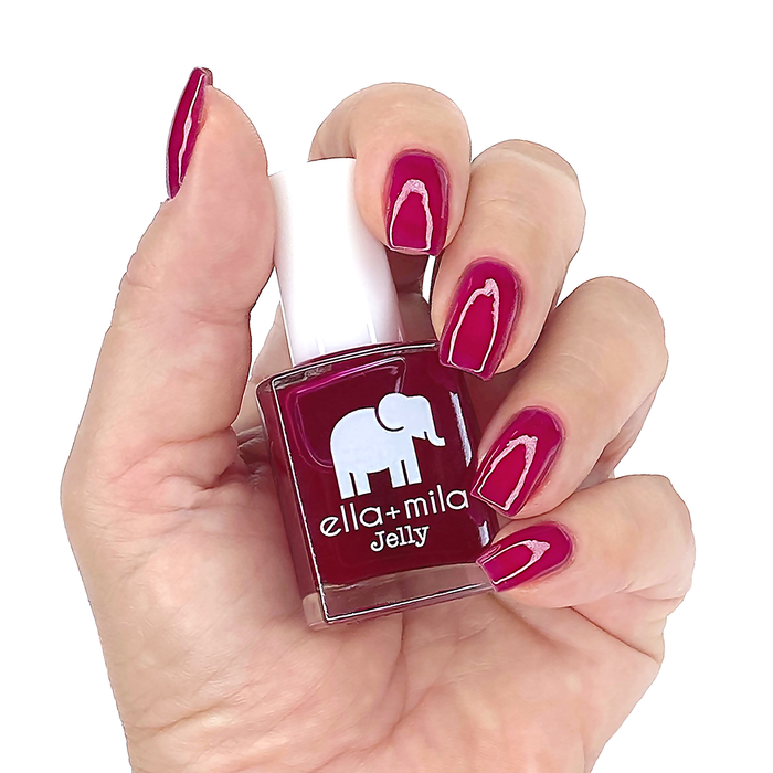Suga Suga fuchsia jelly nail polish manicure on a light skin tone with the bottle