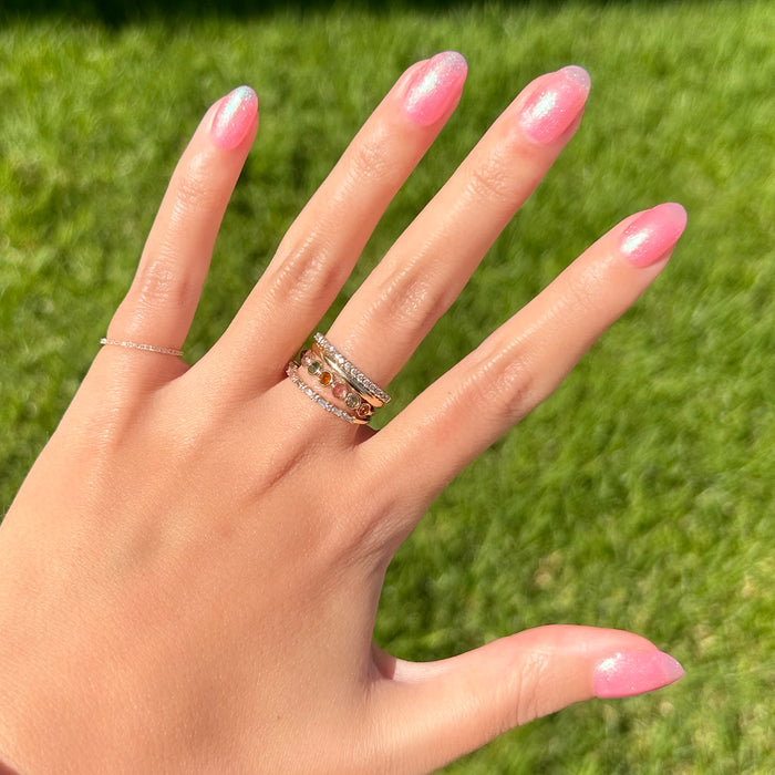 Hand displaying a shiny sweet pink manicure using That’s Amoray quick-dry gel polish in natural sunlight outdoors