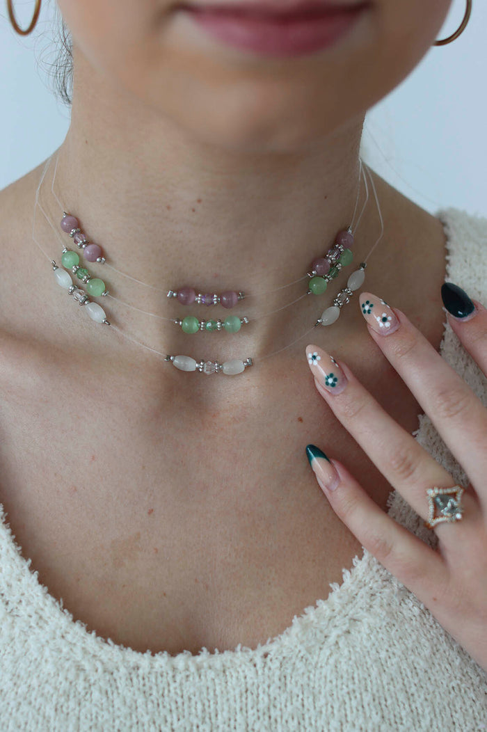 Girl poses with three chokers on