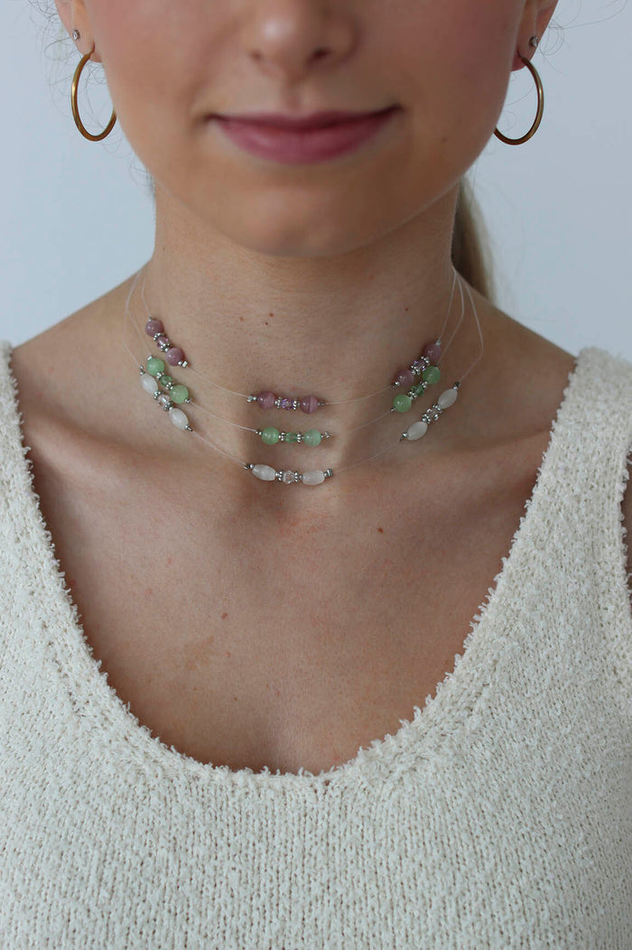 girl poses with three chokers on