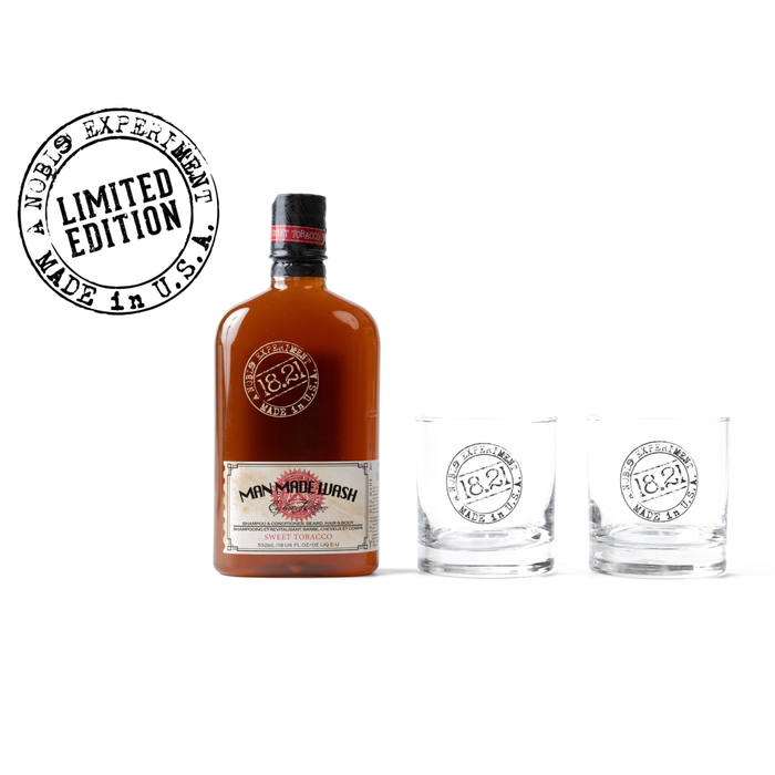Bottle of Man Made Wash whiskey with two glasses on a white background, featuring '1821' branding.