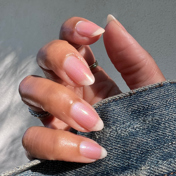 The Golden Effect Top Coat layering a subtle golden shimmer over natural nails for a glowing long-lasting mani look