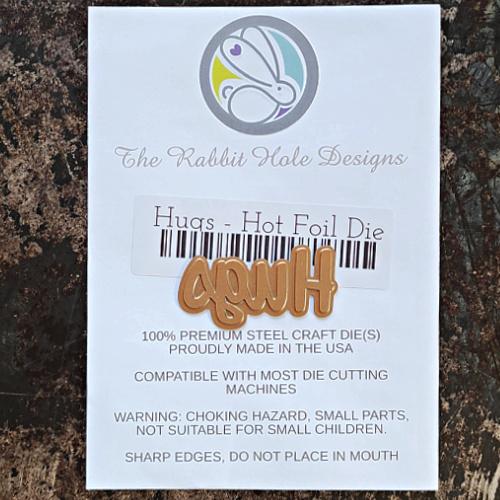 The Rabbit Hole Designs - Scripty Word Hot Foil Plate - Hugs. Create a stunning, letterpress feel to all your projects using our new hot foil dies! Designed to work in any standard hot foil system, be sure to follow the instructions in your manual for a standard hot foil plate. Made in the USA.  Coordinates with Hugs - Scripty 3x4 Stamp Set & Hugs - Scripty Word with Shadow Dies. Available at Embellish Away located in Bowmanville Ontario Canada.