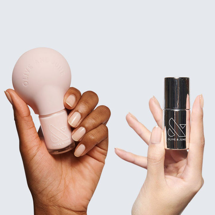 Two hands holding polish bottles from THE STARTER SET with neutral manicured nails for an easy at-home mani
