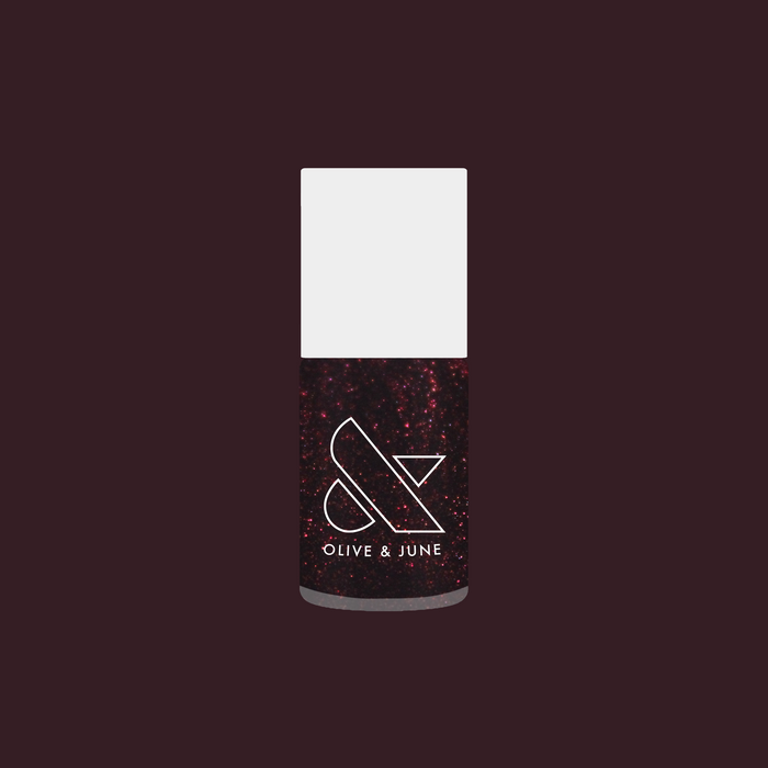 Olive and June nail polish bottle in To Me, You Are Perfect deep plum metallic shimmer shade for manicure.