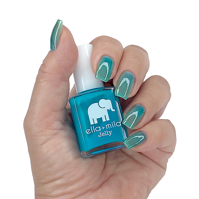 Tooti Fruiti Lover Boy water blue jelly nail polish on a medium skin tone, hand holding the bottle