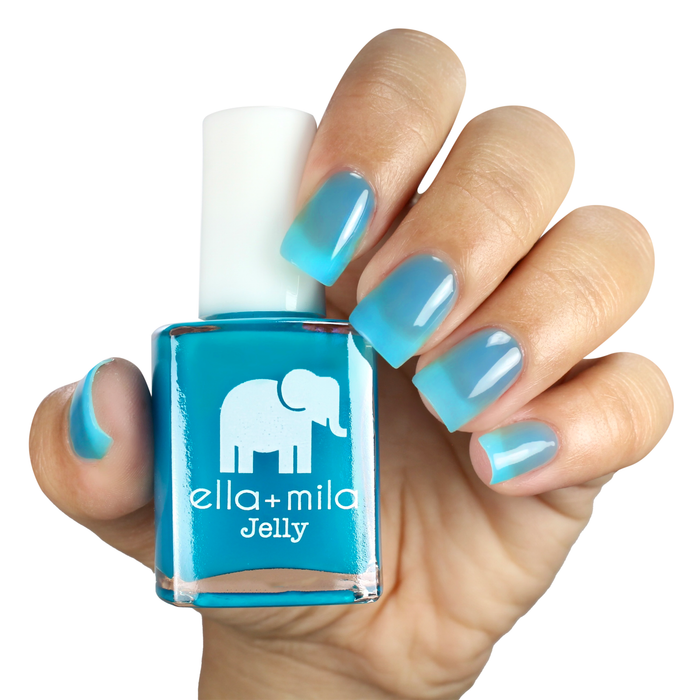 Tooti Fruiti Lover Boy sheer blue jelly nail polish manicure on a light skin tone with the bottle