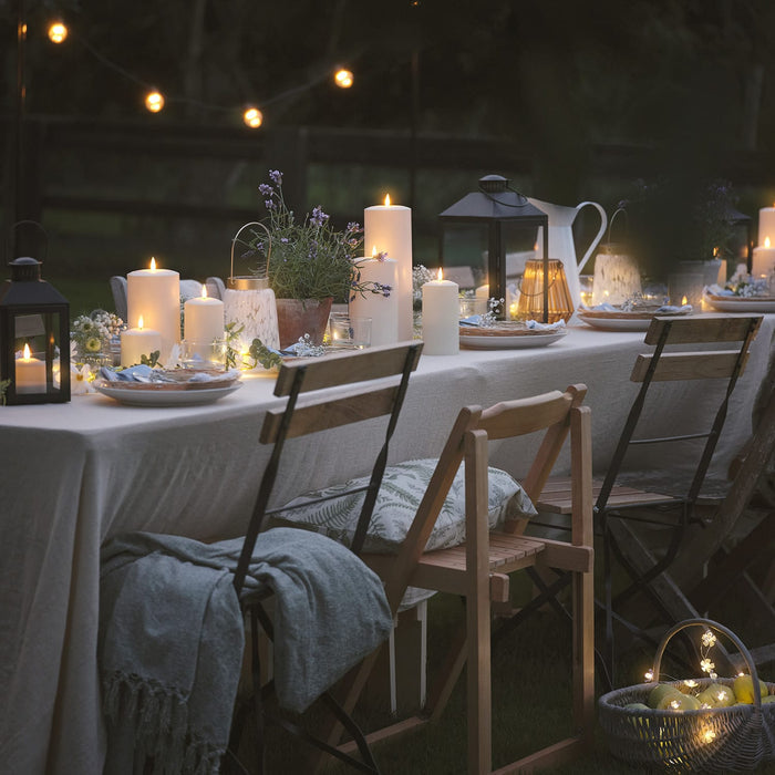 Outdoor dining table with LED candles and lanterns