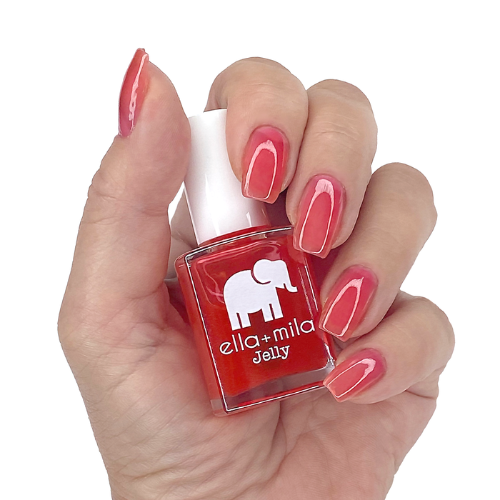 Watermelon Jelly Rancher sheer pink red jelly nail polish manicure on a light skin tone with the bottle