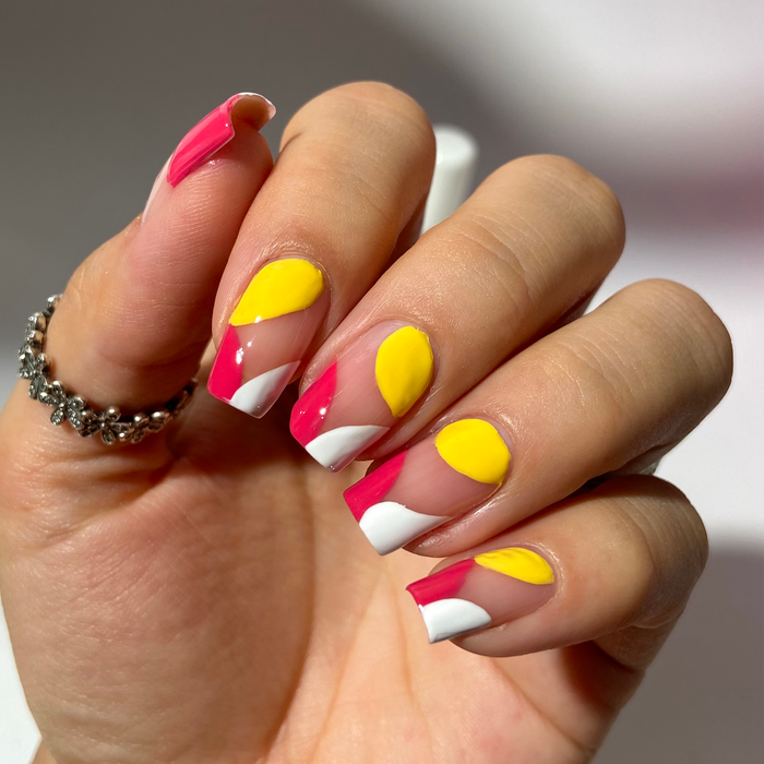 Yellow Ceramic liner used for yellow, red and white abstract nail art on a medium skin tone