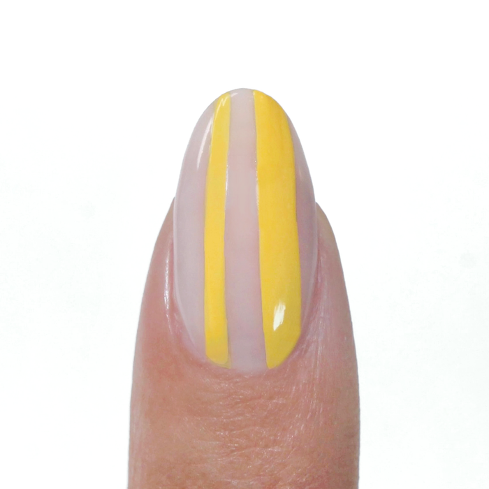 Yellow Ceramic liner used for yellow vertical stripes on a sheer nude nail